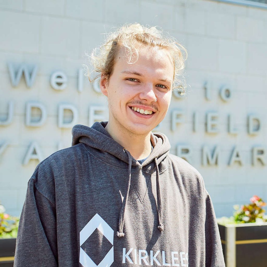 A young Kirklees College male student stood outside Huddersfield Royal Infirmary