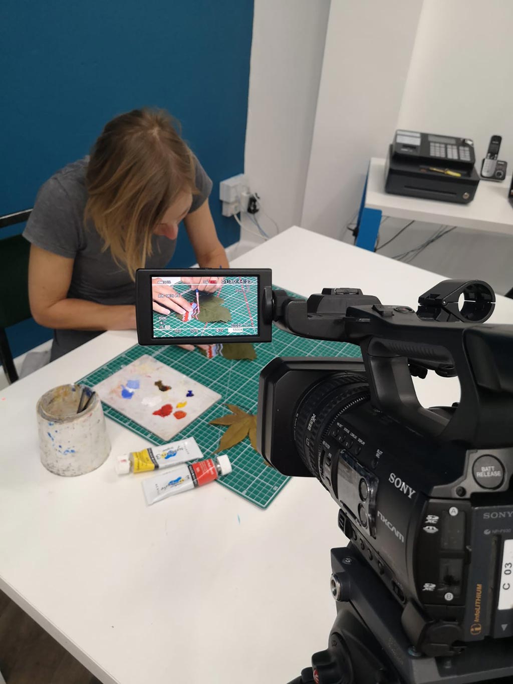 Woman crafting in front of camera