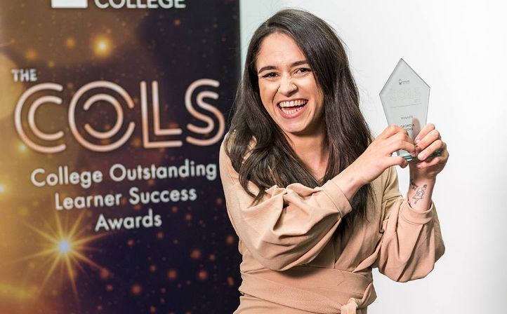 Female student accepting an awards at the student life awards