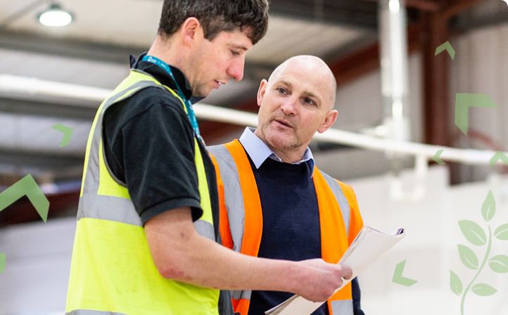 Male apprentice stood chatting with his tutor