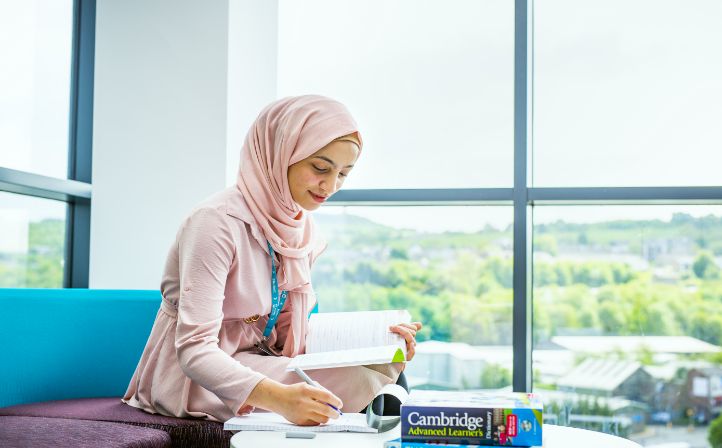 Female student in headscarf studying her books