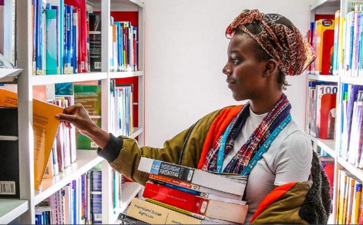 Female student browsing books in the college library