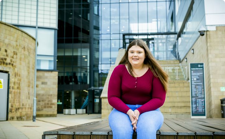 Kirklees student sat outside Kirklees College Huddersfield Centre