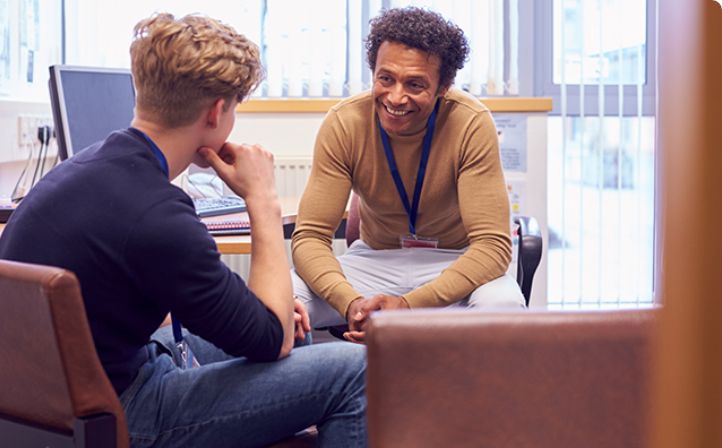 Male student talking to his tutor