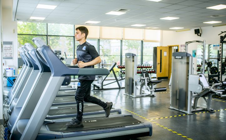 Sports Academy student running on a treadmill in the gym