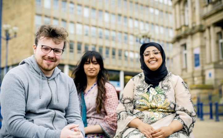 Three student stood outside Huddersfield Centre Campus