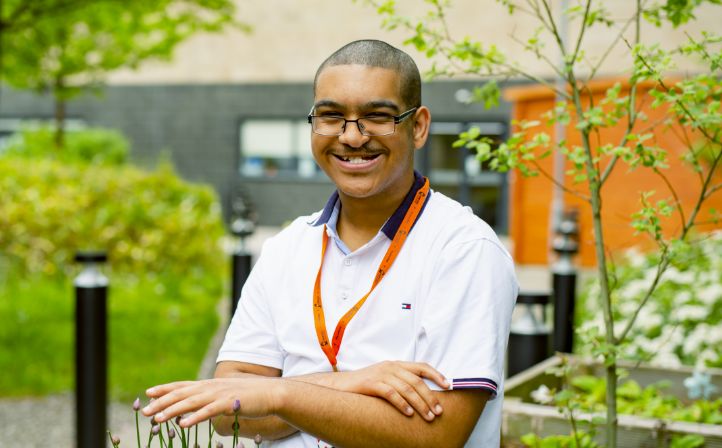 Young mixed race male student smiling into the camera