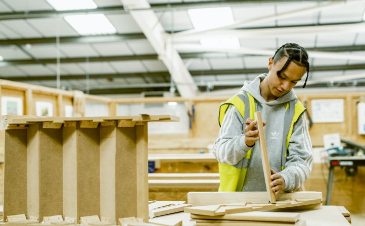 A young construction student practicing his wood work