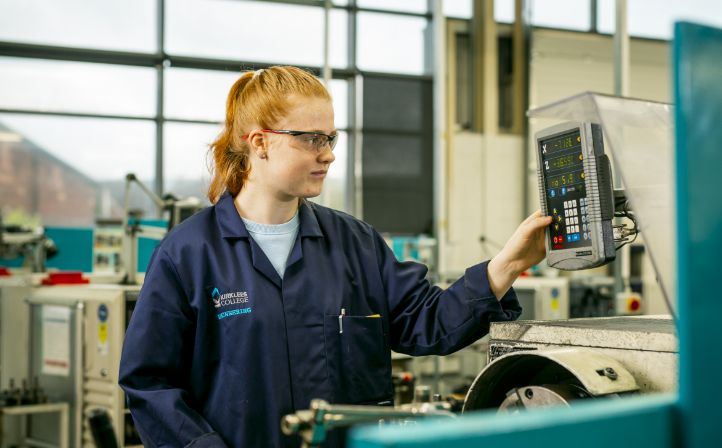 Female student operating a CNC lathe