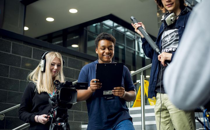 Two students filming as part of their coursework