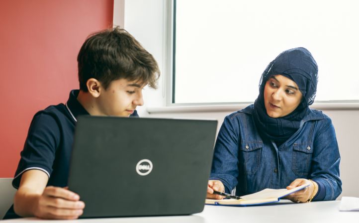 Two Kirklees Students working on a computer and discussing