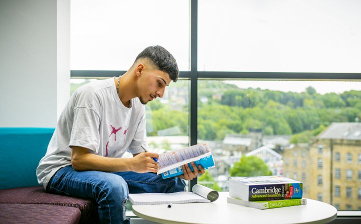 Male student reading his course work