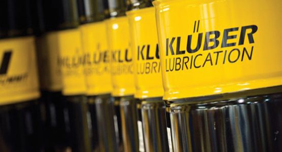 A row of kluber lubrication bottles on a shelf