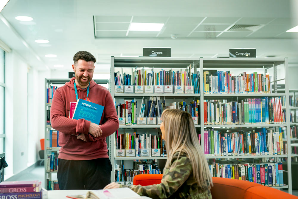 Male and Female Access to Higher Education Students Talking and Studying in Learning Resource Centre