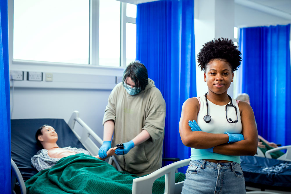 Health and Social Care Student in Full Equipment Looking at the Camera with Folded Arms