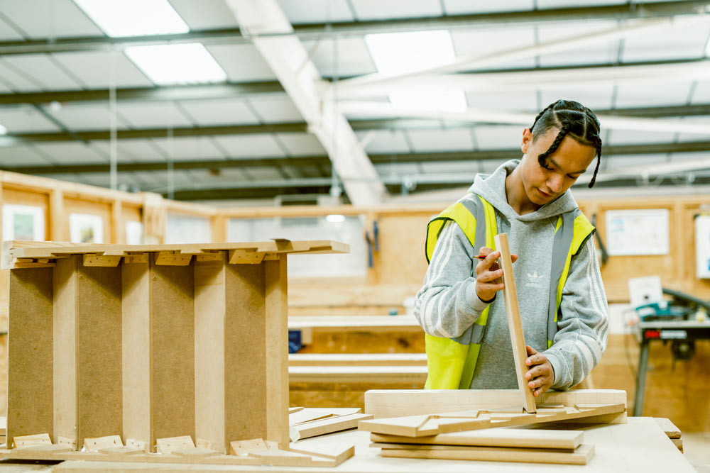 Male Student Studying For Carpentry Apprenticeship At College