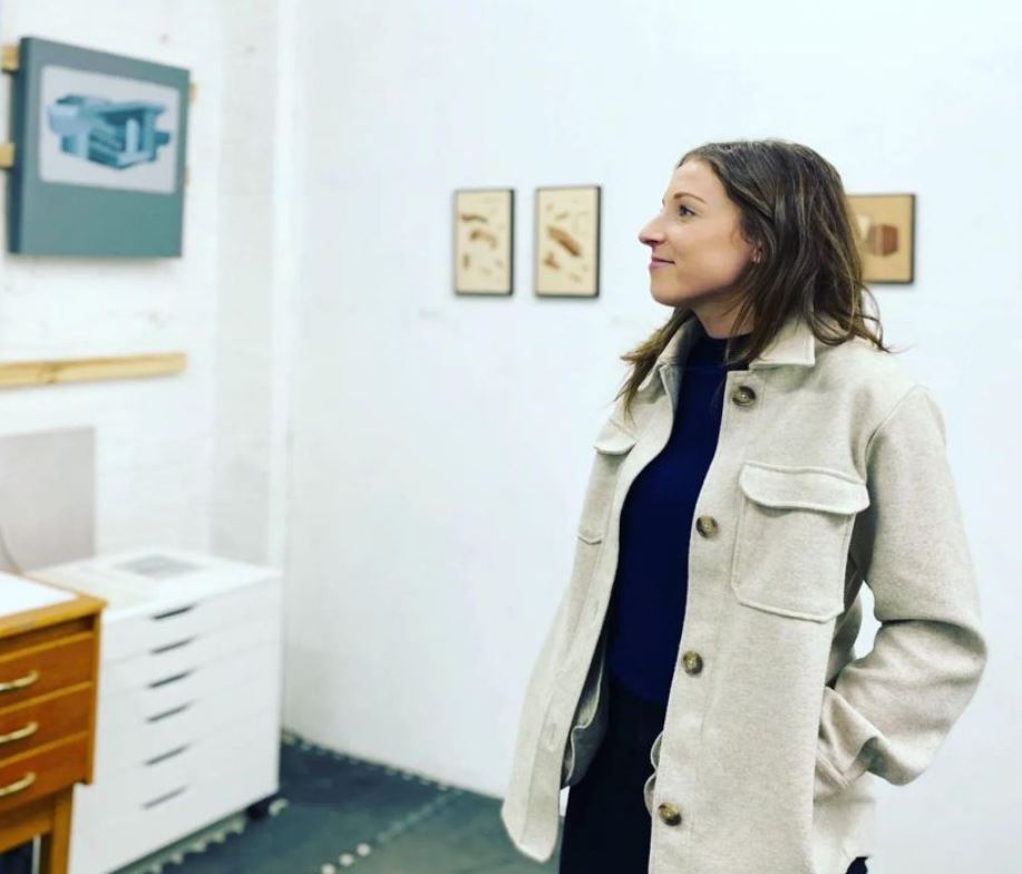 Olivia Turner stands in an art gallery
