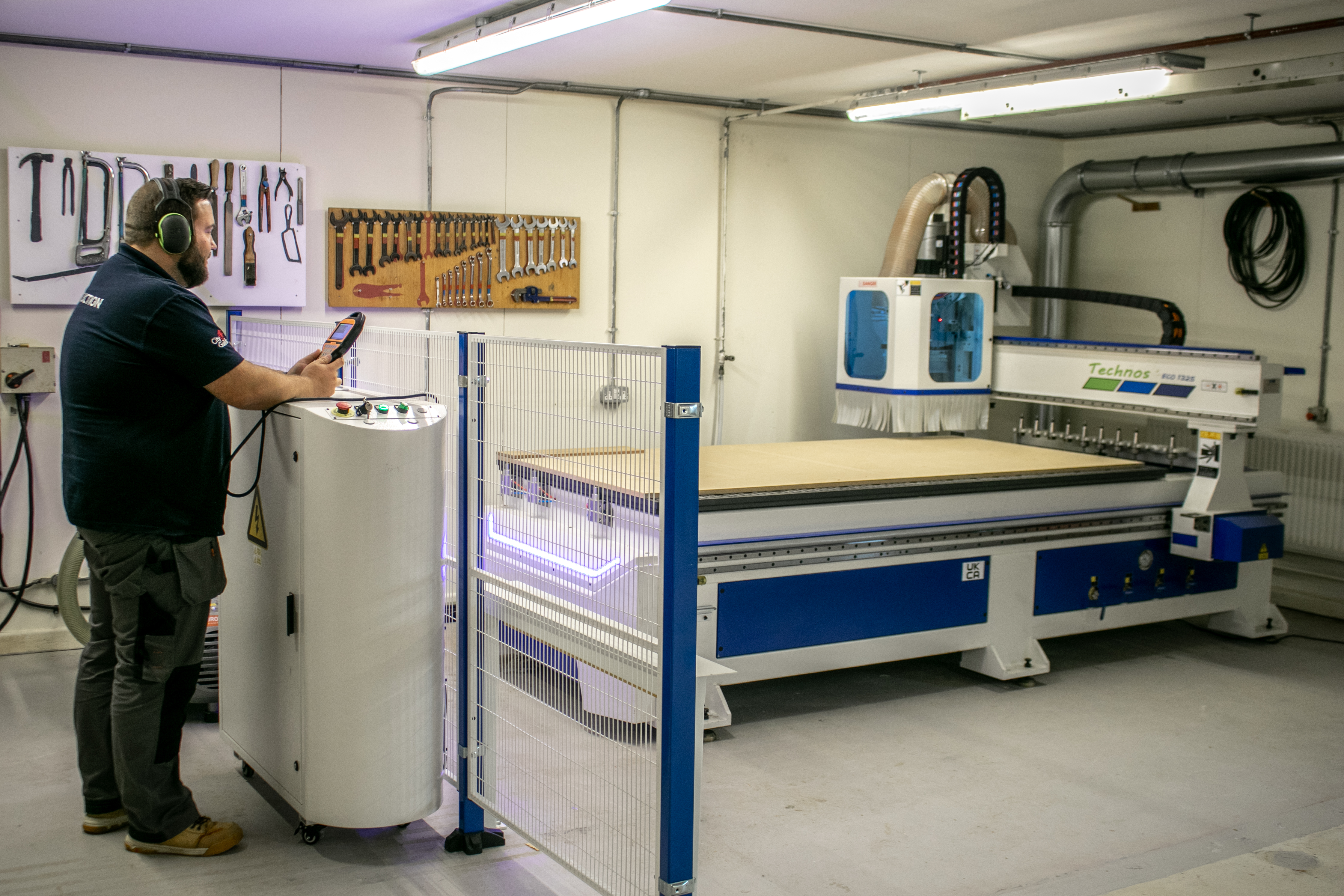 Man in hard hat operating a new CNC machine