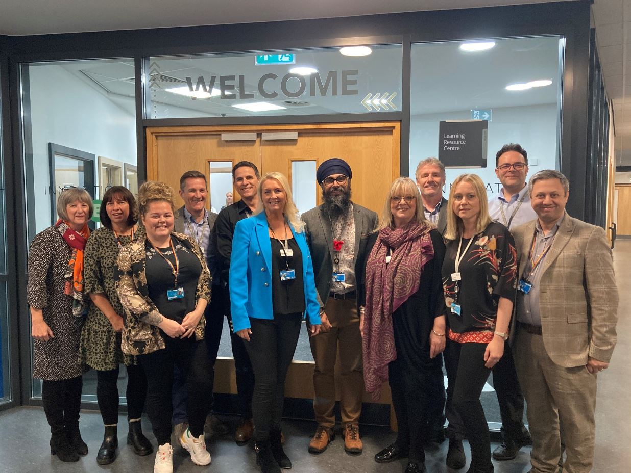 Senior Members of the Kirklees College team line up in front of the entrance to the new Innovation Hub