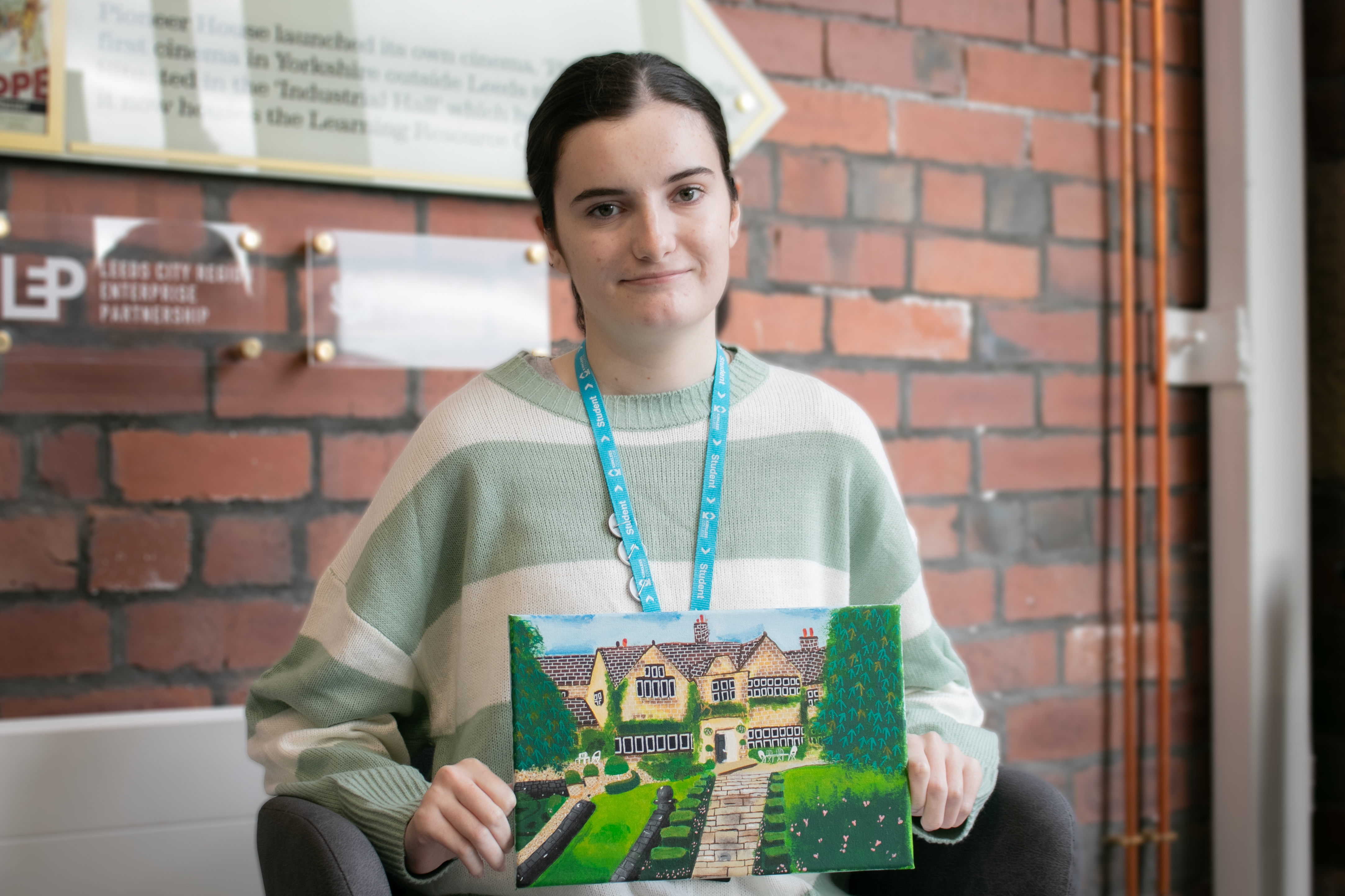 Rosie holding her painting of Holdsworth House