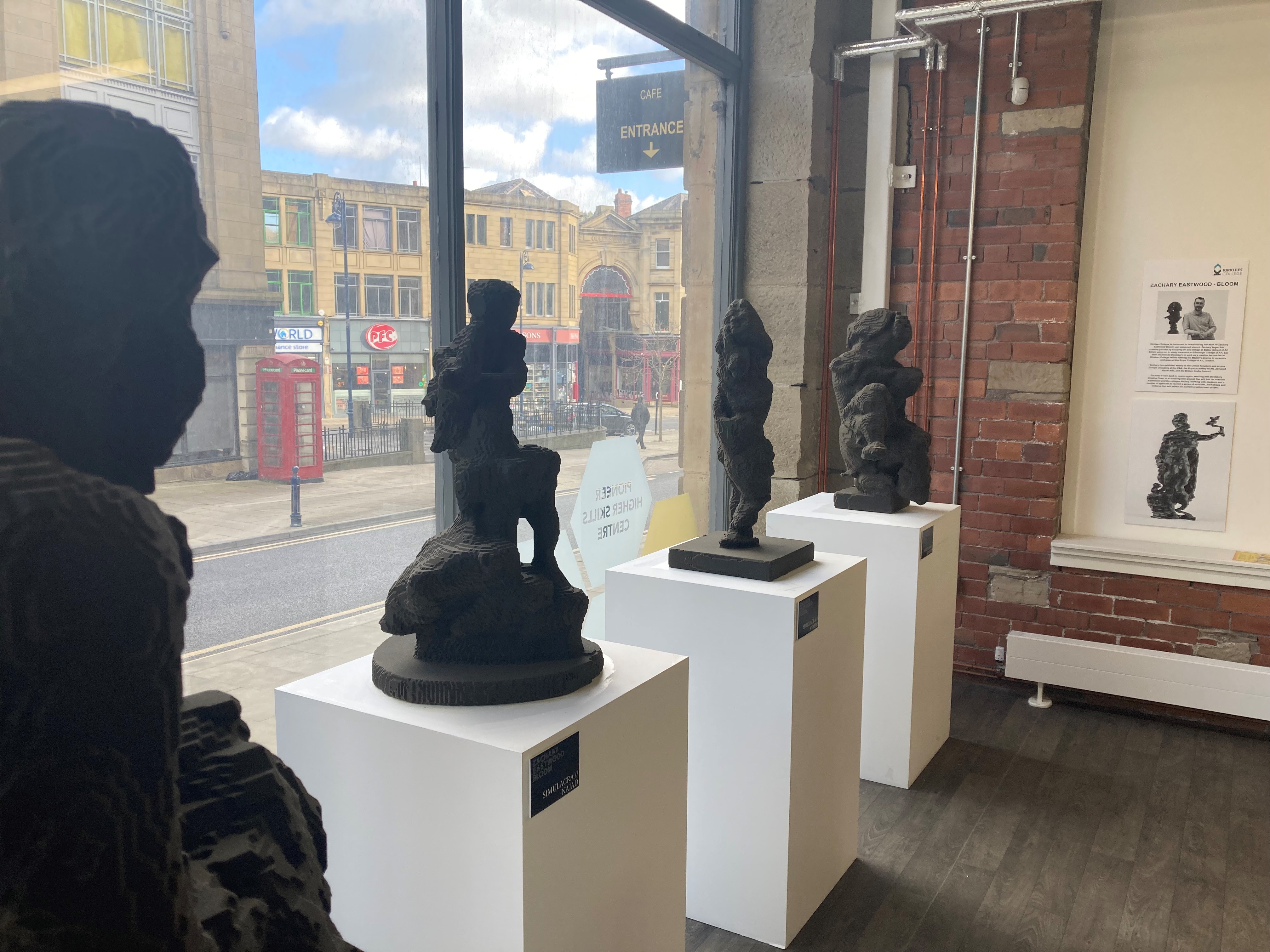 four sculptures displayed in the window of Pioneer Higher Skills Centre