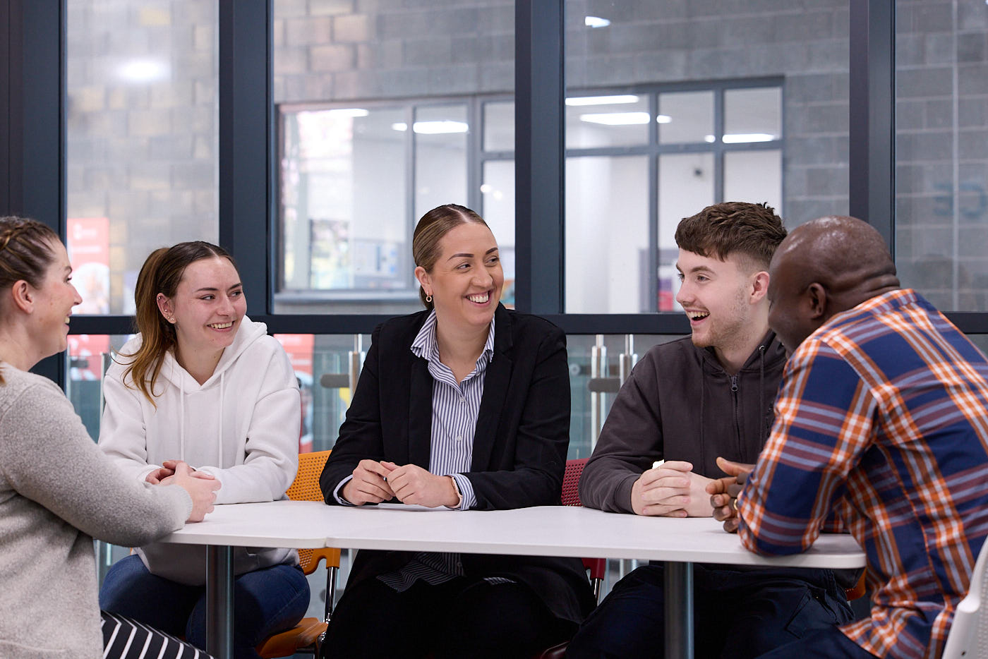 students sit around a table chatting