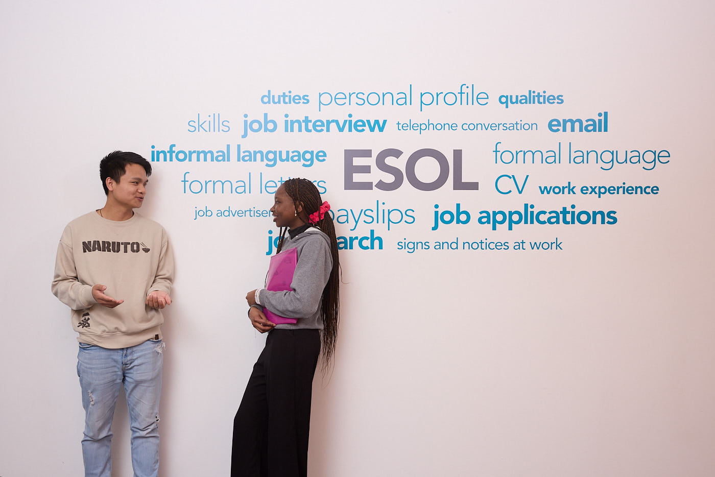 ESOL wall with students infront