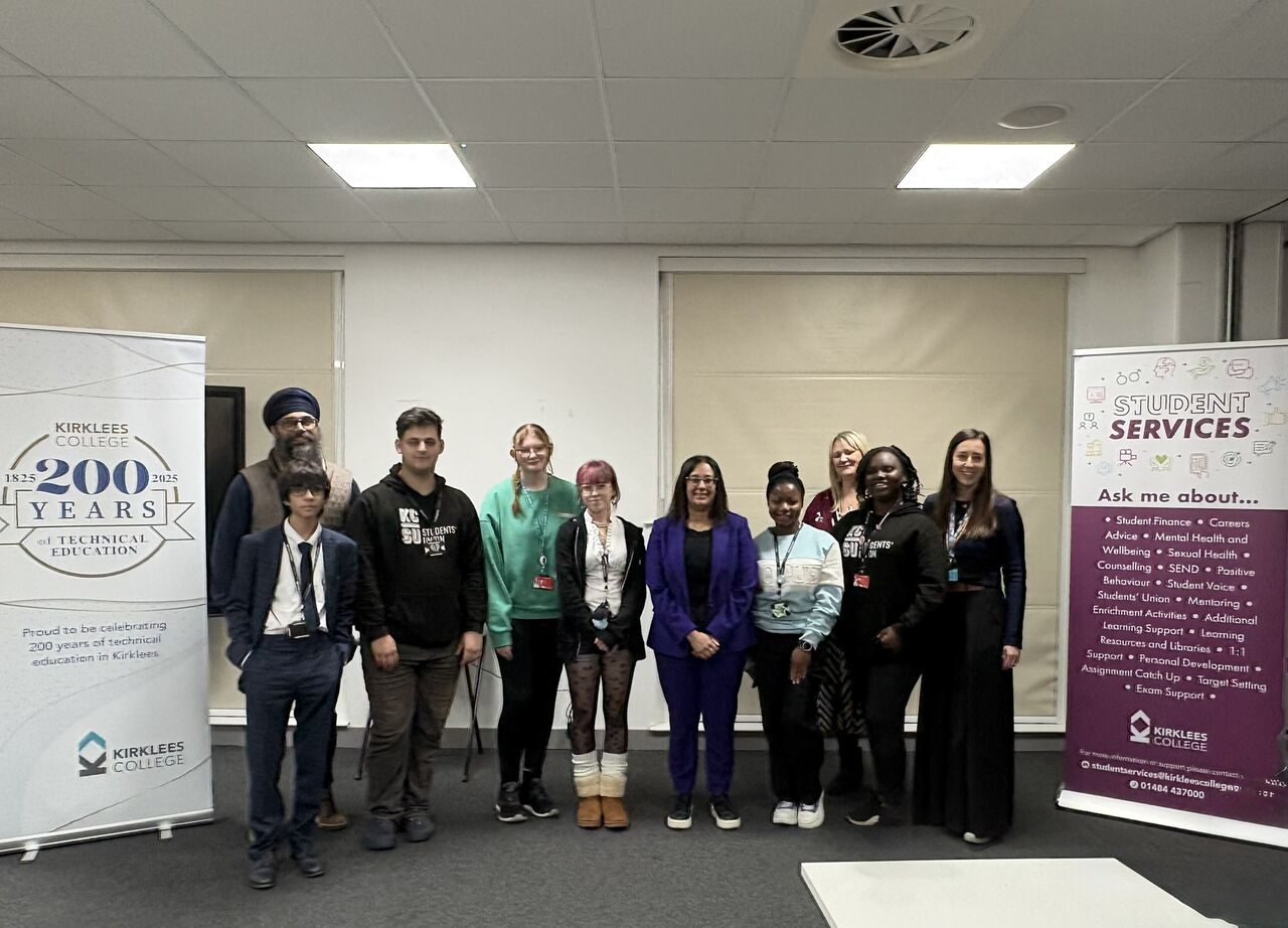 Kirklees College students stand in a line with Harpreet Uppal in the middle