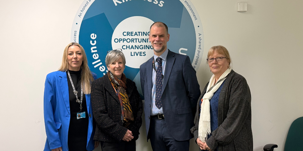 Alasdaire Duerden poses for picture with Kirklees College staff