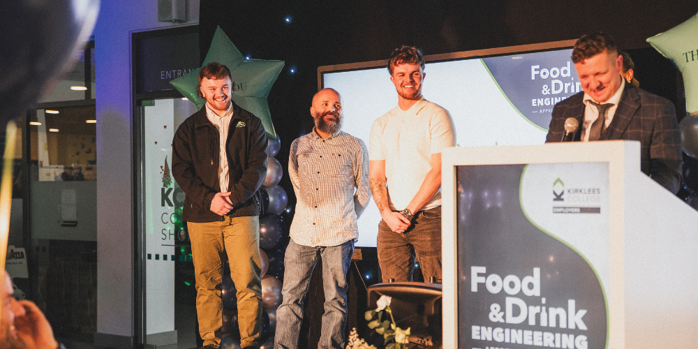 Students and staff on stage at awards ceremony