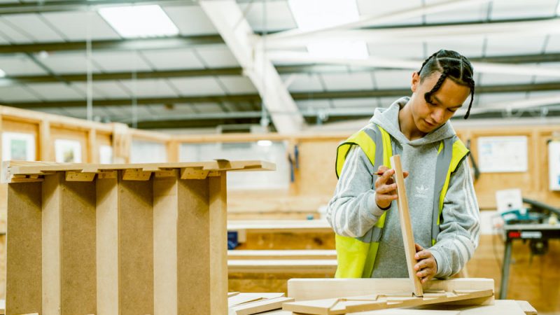 Male Joinery Student Holding Wood and Working in a Workshop at Brunel Construction Centre