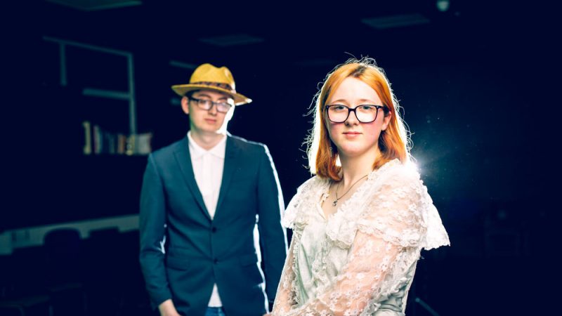 Male and Female Performing Arts Students Wearing Constumes and Looking Into the Camera