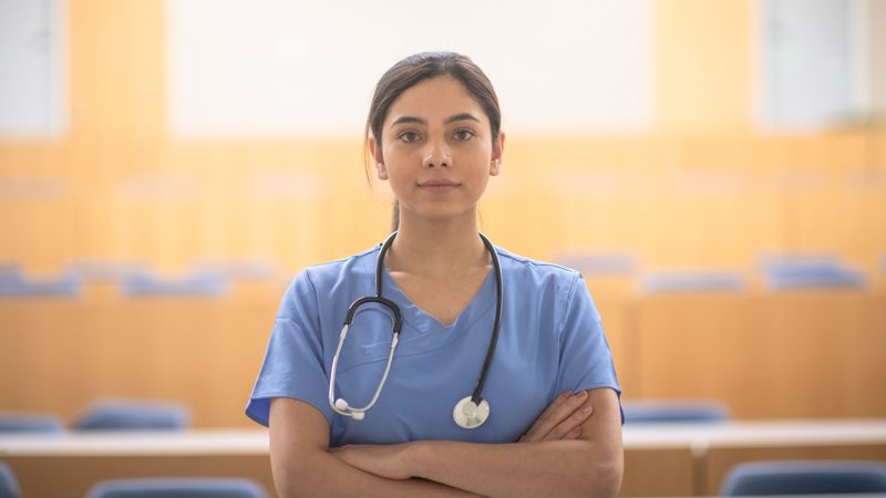 A young female nurse stood facing the camera