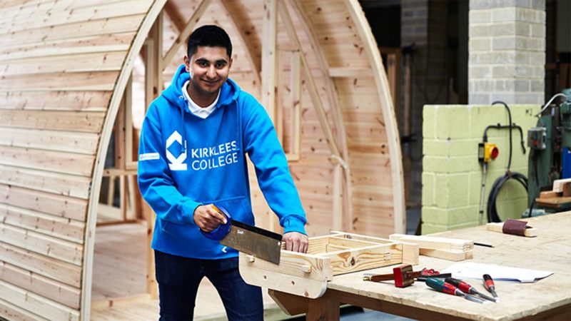 A young male joinery apprentice working in the Kirklees workshop