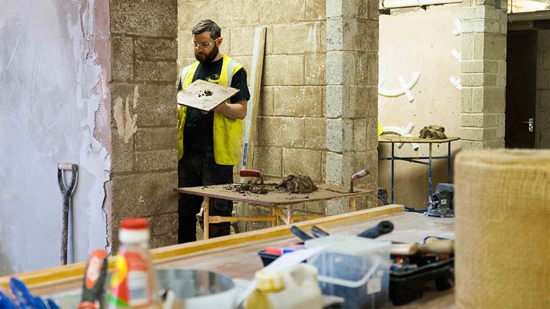 A male student Plastering in the kirklees construction centre