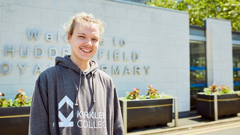 A young Kirklees College male student stood outside Huddersfield Royal Infirmary